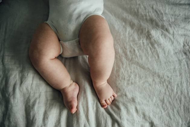 Creative Highlights Symbolbilder Close up of chubby baby s legs laying on bed at home. United States, North Dakota, Bismarck R_KIFR231113-1286847-01 ,model released, Symbolfoto