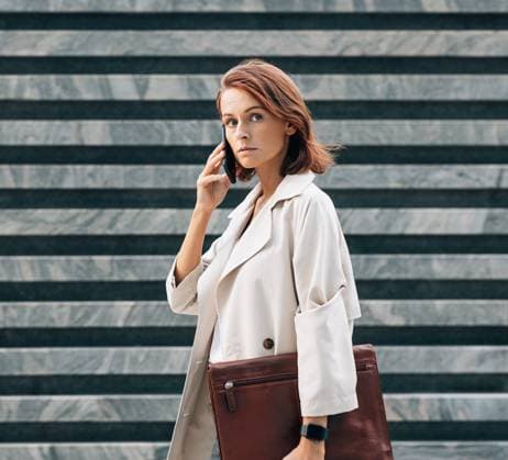 Creative Highlights Symbolbilder Confident businesswoman in coat talking on the mobile phone looking away Confident businesswoman in coat talking on the mobile phone looking away Copyright: xxArtemxVarnitsinx