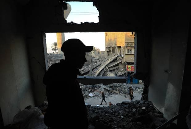 (231118) -- GAZA, Nov. 18, 2023 -- A man checks the rubble of buildings destroyed in an Israeli military operation in the southern Gaza Strip city of Khan Younis Nov. 17, 2023. Gaza s government media office announced on Friday that the total number of Palestinian deaths in the enclave has exceeded 12,000 since the start of the Israel-Hamas conflict on Oct. 7. (Photo by Xinhua) MIDEAST-GAZA-PALESTINIAN-ISRAELI CONFLICT YasserxQudih 