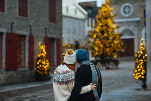 A romantic couple hugging in a charming street decorated with sparkling Christmas trees and vintage architecture in Quebec, Canada Model Released CamilleGirard_ID13407_408495_020 Copyright: xCamillexGirardx