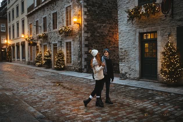 A romantic couple walking and admiring a beautifully decorated Christmas tree and illuminated street during the holiday season in Quebec, Canada Model Released CamilleGirard_ID13407_408499_022 Copyright: xCamillexGirardx
