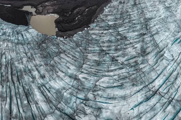 Creative Highlights World From above aerial drone view of glacier near muddy sea water with blue textured ice in Vatnajokull National Park located in Iceland Model Released JuanLopez_ID17501_530916_023 Copyright: xJuanxLopezx
