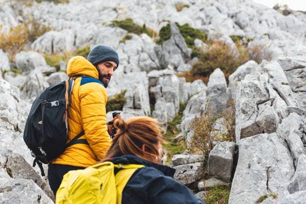 man and woman climbing a mountain among the rocks. couple hiking in the high mountains. outdoor sports and healthy lifestyle. Model Released AlbertoMenendez_ID15124_461529_009 Copyright: xALBERTOxMENENDEZxCERVEROx MENIxFx
