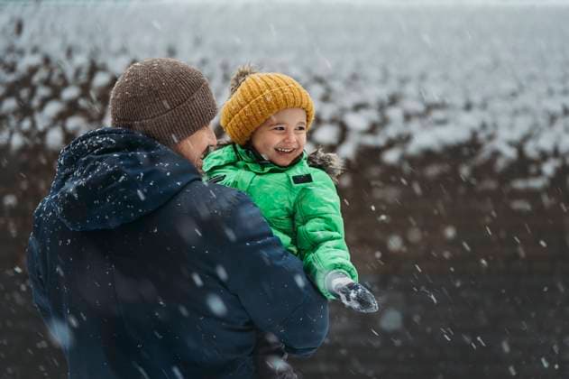 Happy boy enjoying snowy weather with father in winter model released, Symbolfoto, ANAF02381