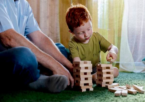 Redhead boy stacking blocks with grandfather at home model released, Symbolfoto, MBLF00088