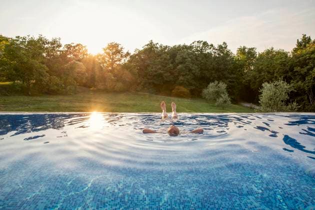 Senior man relaxing in swimming pool at sunset model released, Symbolfoto property released, MAMF02898