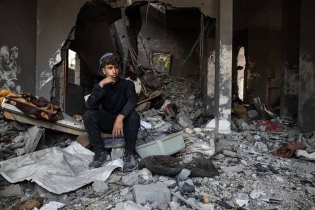 November 22, 2023: A Palestinian youth observes the destruction in a residential area of Deir Al Balah, in the central Gaza Strip, hit by Israeli bombardments - ZUMAd99_ 20231122_zap_d99_017 Copyright: xAdelxAlxHwajrex