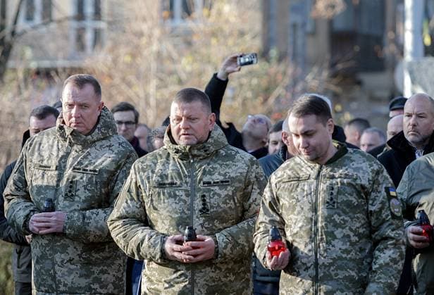 KYIV, UKRAINE - NOVEMBER 25, 2023 - Chief of the General Staff of the Armed Forces of Ukraine, Lieutenant General Serhii Shaptala, Commander-in-Chief of the Armed Forces of Ukraine, General Valerii Zaluzhnyi and Chief of the Defence Intelligence of Ukraine, Lieutenant General Kyrylo Budanov (L to R) leave vigil lanterns at the Bitter Memory of Childhood monument during the events commemorating the 90th anniversary of the Holodomor of 1932-1933, the genocide of the Ukrainian people, at the National Museum of the Holodomor-Genocide on Holodomor Remembrance Day, Kyiv, capital of Ukraine. On the fourth Saturday of November, Ukraine commemorates the victims of the Holodomor, the 1932?33 man-made famine that killed millions. Holodomor Remembrance  Copyright: xKirillxChubotinx