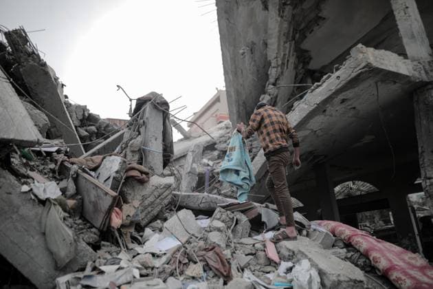 November 25, 2023: Deir Al-Balah, Gaza Strip, Palestine. 24 November 2023. Palestinians sit among the rubble of their destroyed home in Deir Al-Balah, during a truce after 7 weeks of incessant Israeli bombardments. On Friday 24 November a four-day humanitarian truce between Israel and Hamas started, with displaced Gazans visiting their homes and assessing the damage from the continuous Israeli strikes. Yet, displaced Palestinians in southern Gaza were not allowed to travel north to assess the damage to their homes and properties - ZUMAd99_ 20231125_zap_d99_035 Copyright: xAdelxAlxHwajrex