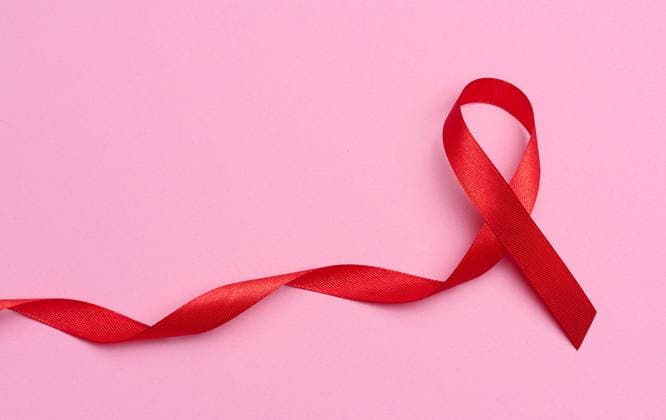 A silk red ribbon in the form of a bow on a pink background, a symbol of the fight against AIDS and a sign of solidarity and support A silk red ribbon in the form of a bow on a pink background, a symbol of the fight against AIDS and a sign of solidarity and support Copyright: xZoonar.com DANKOxNx 20017613