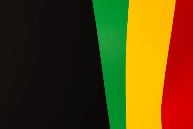 Green, yellow and red papers with copy space on black background. Black history month, africa, black culture and history concept.