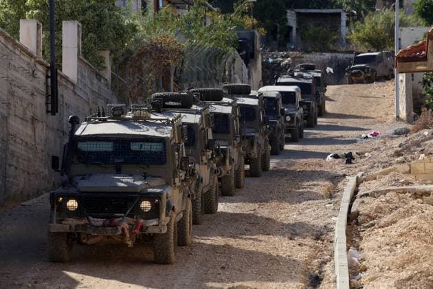 (231129) -- JENIN, Nov. 29, 2023 -- Israeli military vehicles are seen during a raid in the West Bank city of Jenin, on Nov. 29, 2023. At least two Palestinian children were killed by Israeli army gunfire during its raid on the West Bank city of Jenin and its refugee camp, the Palestinian Health Ministry said on Wednesday. (Photo by Xinhua) MIDEAST-JENIN-ISRAEL-RAID NidalxEshtayeh 