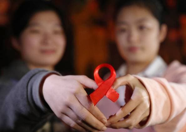 (231130) -- HENGYANG, Nov. 30, 2023 -- Students show a red ribbon during an event to raise awareness of AIDS at University of South China in Hengyang, central China s Hunan Province, Nov. 29, 2023. The World AIDS Day falls on Dec. 1. (Photo by Xinhua) CHINA-HUNAN-HENGYANG-WORLD AIDS DAY (CN) CaoxZhengping 