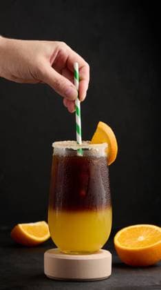 Iced coffee with orange juice in a transparent glass, refreshing bumble coffee on the table Iced coffee with orange juice in a transparent glass, refreshing bumble coffee on the table Copyright: xZoonar.com DANKOxNx 20465793
