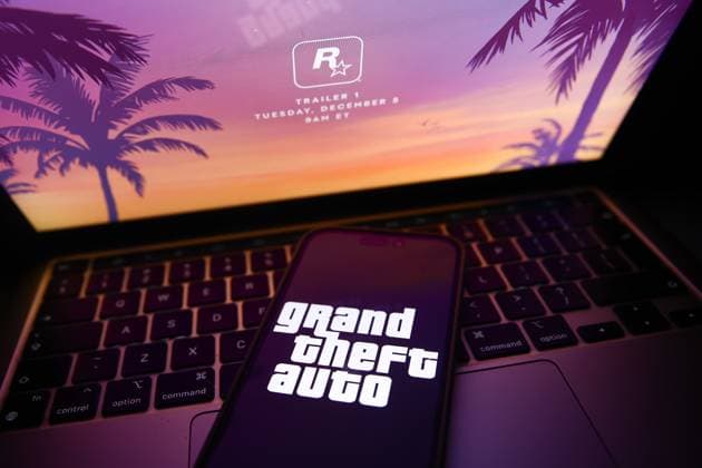 Rockstar Grand Theft Auto Announcement Photo Illustrations Rockstar website announcing GTA 6 trailer displayed on a laptop screen and Grand Theft Auto logo displayed on a phone screen are seen in this illustration photo taken in Krakow, Poland on December 3, 2023. Krakow Poland  Copyright: xJakubxPorzyckix originalFilename: porzycki-rockstar231203_npiOO.jpg