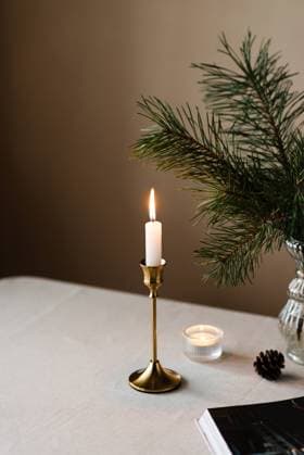 Cozy home atmosphere with fir branches and candles on the table R_GYKH231129-1297092-01