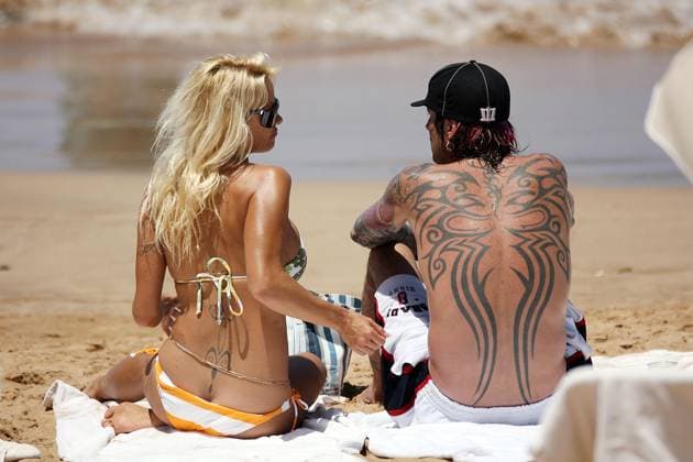 Pamela Anderson sports a new colorful bikini on the final day of her family vacation in Hawaii with Tommy and the kids. 14826, MAUI, HAWAII. Saturday April 14, 2007. Pamela Anderson sports a new colorful bikini on the final day of her family vacation in Hawaii with Tommy Lee and their two boys Dylan and Brandon. The former Baywatch babe returned from the warm tropical waters of Hawaii with a barely there sexy two-piece bikini on and pair of blue flippers. She looked happy to be spending quality time with her on again off again ex-hubby Tommy Lee. The pair lay in the sand while watching the children play in the water. Tommy showed that he still has no manners by picking his nose and then rolling his catch around in his fingers.Photograph: W  Copyright: xWillxBinns xPacificcoastnews.comx xAvalonx 0523138955