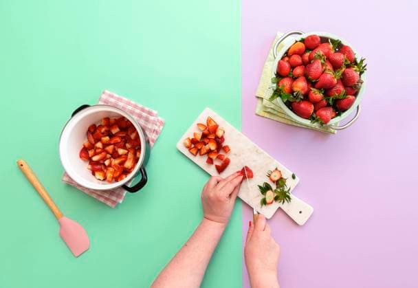 Making strawberry jam with fresh fruits. Slicing strawberries Woman preparing strawberry jam on duotone seamless background. Flat lay with the making of marmalade. Slicing strawberries to make jam. Copyright: xZoonar.com DanielaxSimonaxTemneanux 15484565