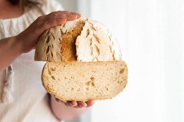 Sourdough bread hold in hands. No yeast bread Unrecognizable woman holding sourdough bread, homemade with wheat flour and starter. No yeast bread. Natural leaven loaf. Rustic round bread. Copyright: xZoonar.com AndreixUrechex 15484652