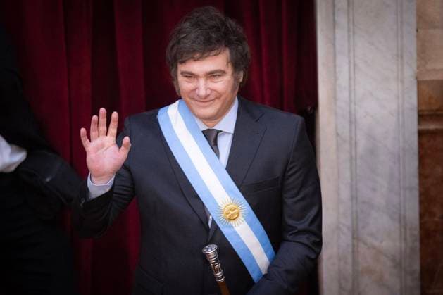 (231211) -- BUENOS AIRES, Dec. 11, 2023 -- Argentina s new President Javier Milei waves to supporters in Buenos Aires, Argentina, Dec. 10, 2023. Javier Milei, a liberal politician and economist, assumed the Argentine presidency Sunday in a ceremony held at the National Congress in Buenos Aires, the country s capital. The outgoing head of state, Alberto Fernandez, placed the presidential sash and handed the baton of command to Milei, whose term will last for four years, until Dec. 10, 2027. (Photo by Xinhua) ARGENTINA-BUENOS AIRES-JAVIER MILEI-INAUGURATION MartinxZabala 