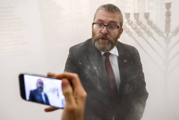 December 12, 2023, Warsaw, Poland: Grzegorz Braun, a member of the far-right Confederation party is seen after using a fire extinguisher on to put out candles on a menorah that was lit during Hannukah celebration in the parliament building in Warsaw, Poland on December 12, 2023. Warsaw Poland - ZUMAz156 20231212_zip_z156_001 Copyright: xBeataxZawrzelx