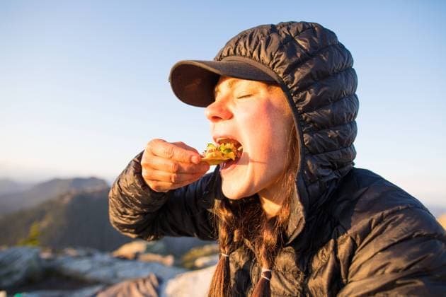 Active woman eats chips and salsa outdoors, on mountain. Vancouver, British Columbia, Canada CR_JDIP231215-1229083-01 ,model released, Symbolfoto