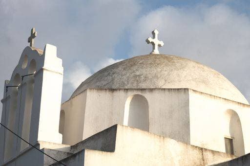 A low angle shot of an old chapel touching the cloudy sky in the Greek island of Folegandros 149301 RECORD DATE NOT STATED