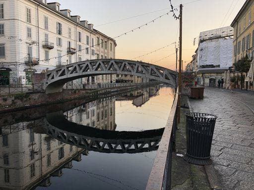A beautiful shot of the bridge in the canal of temakinho navigli in milan italy with an orange sky in the background 158403 RECORD DATE NOT STATED