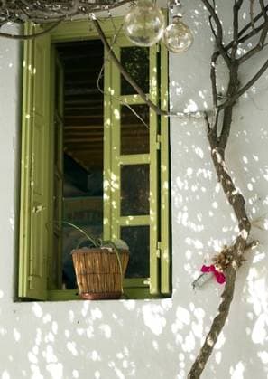 An old taverna white wall with a green window and a tree next to it in Folegandros, Greece 168110 RECORD DATE NOT STATED