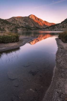 A morning sunrise view of the Vihren peak reflected in the Banderitsa lake, Pirin National Park, Bulgaria 224491 RECORD DATE NOT STATED