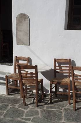 A traditional small cafe in the old twn on the beautiful and remote Greek island of Folegandros. Tables and chairs at the entrance. 386394 RECORD DATE NOT STATED
