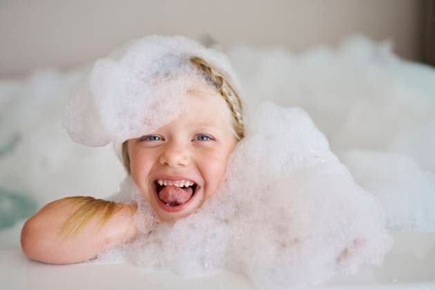 Creative Highlights Symbolbilder Cheerful girl covered in soap suds and sticking out tongue model released, Symbolfoto property released, ANNF00617