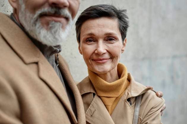 Creative Highlights Symbolbilder Adult woman looking at camera standing next to her husband with gray beard outdoors model released, Symbolfoto, KPEF00396