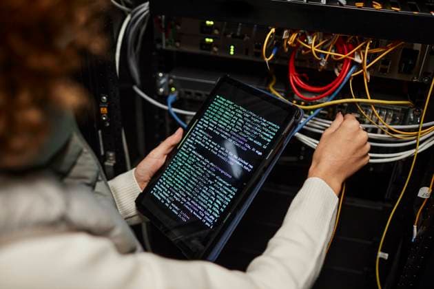 Engineer working on tablet PC with computer codes and setting up database model released, Symbolfoto property released, KPEF00478