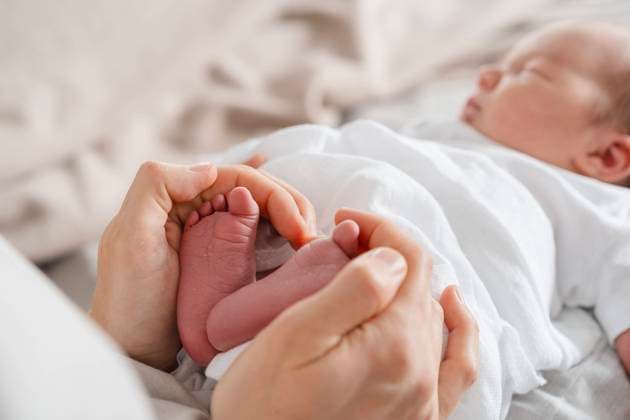 Mother holding newborn son s feet in hand model released, Symbolfoto property released, NDEF01464