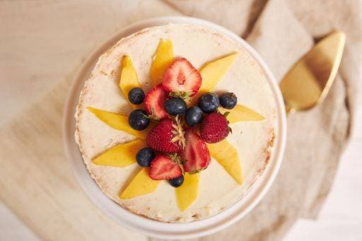An overhead shot of delicious mango strawberry summer naked cake on a white table with white background 607004 RECORD DATE NOT STATED