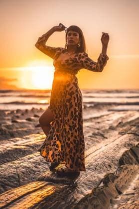 A vertical shot of a young female in leopard dress on a beautiful sunset on the beach 642237 ,model released, Symbolfoto RECORD DATE NOT STATED