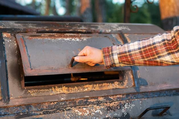 A man in a frilly shirt is looking at an excellent professional grill for re-frying meat. Professional outdoor BBQ. A man in a frilly shirt is looking at an excellent professional grill for re-frying meat. Professional outdoor BBQ Copyright: xZoonar.com SergiyxArtsabax 19513671