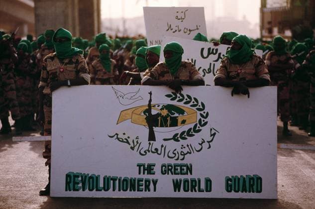 One of Libyan President Muammar Gaddhafi s private African Militias, the Green Revolutionary World Guard, standing just in front of the Nelson Mandela Battalion, another militia that supports the ideals and Green Revolution theories that was created by Gaddafi, during celebrations in the capital Tripoli marking the 20th anniversary of his rise to power. Tripoli Libya EDITORIAL USE ONLY Copyright: xx BarryxIversonxPhotographyx bivphotos003332