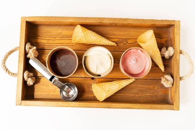 Buckets with different flavors of ice cream, a metal spoon and waffle cups stand on a wooden tray. The concept of healthy and tasty summer food. View from above. Buckets with different flavors of ice cream, a metal spoon and waffle cups stand on a wooden tray. The concept of healthy and tasty summer food. View from above Copyright: xZoonar.com SergiyxArtsabax 20400755