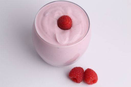 A high angle shot of an organic yogurt smoothie with raspberries on white background 713416 RECORD DATE NOT STATED