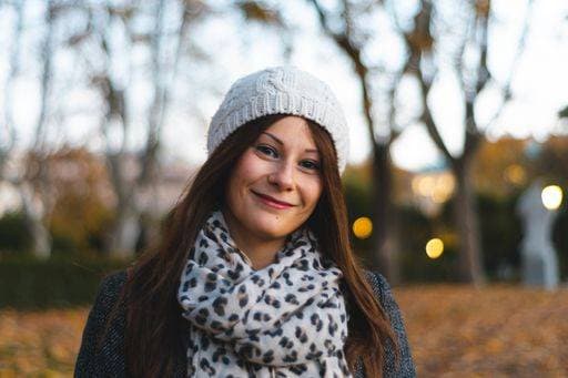 A closeup of a smiling girl wearing a cap and a scarf in winter 1203328 ,model released, Symbolfoto RECORD DATE NOT STATED