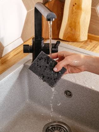 IMAGO Creative: Frühjahrsputz a girl washes a dish sponge R_KUAL24010282-1314898-01