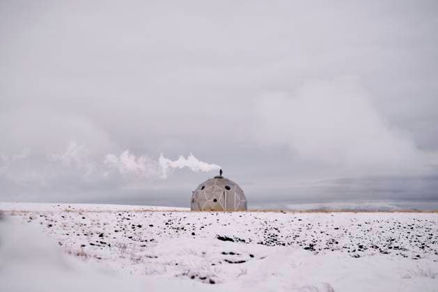 Smoky Igloo on snowy terrain against cloudy sky in winter Hveragerði, Iceland CR_OSBJ240105-1295109-01