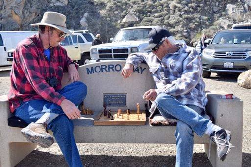 A photo of two men playing a Chess game outside on a bench in Morro Bay in Ca. March 2021 1827802
