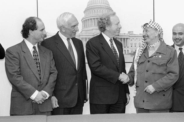 3 4 97 ARAFAT MEETS WITH DEMOCRATS--PLO Chairman Yassar Arafat shakes hands with Sen. Joseph I. Lieberman, D-Conn., during photo opp of meeting with Democrats. Sen. Paul D. Wellstone, D-Minn., and Sen. Frank R. Lautenberg, D-N.J., look on. CONGRESSIONAL QUARTERLY PHOTO BY SCOTT J. FERRELL EDITORIAL USE ONLY Copyright: xx x cqphotos001834