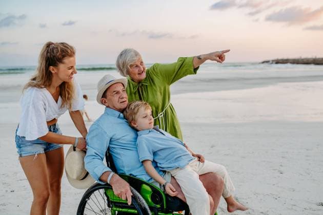 Little boy with his mother and granfather on wheelchair, having fun and enjoying sea together. Little boy with his granfather on wheelchair, having fun and enjoying sea. model released Copyright: xx HHH BODOVCI OMAN 2022 HHH 195