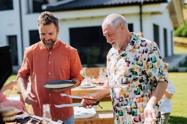 Senior father with adult son grilling outside on backyard in summer family during garden party A senior father with adult son grilling outside on backyard in summer family during garden party model released Copyright: xx HHH FAMILY POOL PARTY 2022 HHH 113