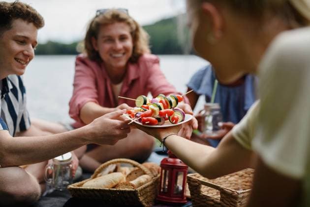 Group of young friends camping near lake and and having barbecue together. Close-up. A group of young friends camping near lake and and having barbecue together. Close-up. model released Copyright: xx HHH SUMMER FRIENDS BS 2022 HHH 146