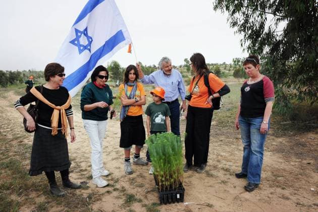 Children Celebrating Tu Bishvat Former Gush Katif settlers and children are planting trees on the Gaza-Israeli border near Kissufim where they once lived in Gaza strip on Jewish holiday of Tu Bishvat in Israel on Monday, February 9, 2009. Tu Bishvat is a minor Jewish holiday in the Hebrew month of Shevat that marks the New Year of the Trees . Customs include planting trees and eating dried fruits and nuts. In Israel, the flowering of the almond tree, which grows wild around the country, coincides with Tu Bishvat. Photo by Rafael Ben-Ari Chameleons Eye.